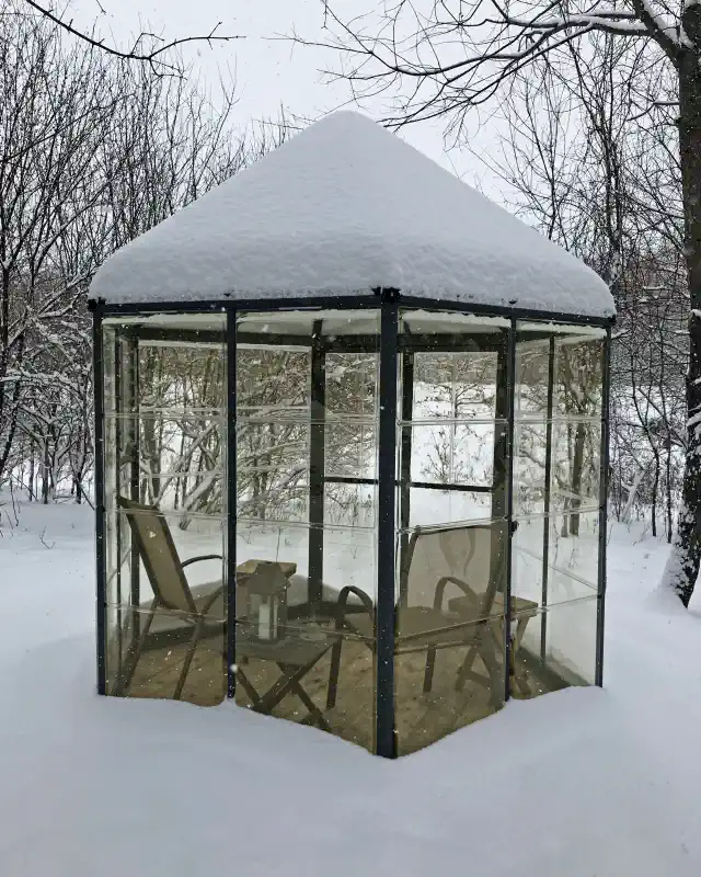 Oasis siltumnīca ziemā ar sniega cepuri
